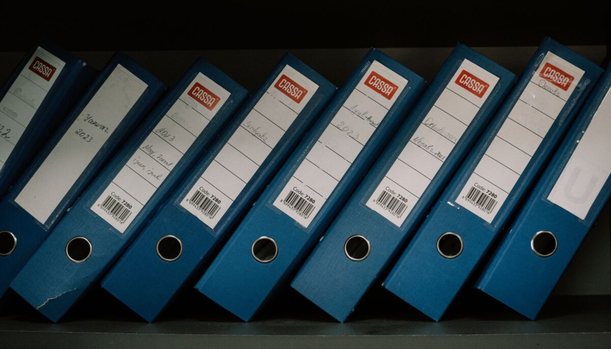 organized blue office binders on shelf